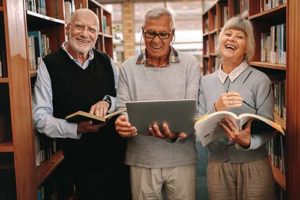 three seniors in educational program readings books