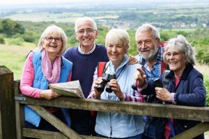 five seniors enjoying group outing by bird watching