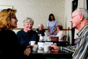 a group of people talking about myths about assisted living programs