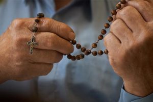 a person holding a rosary in a chaplaincy program