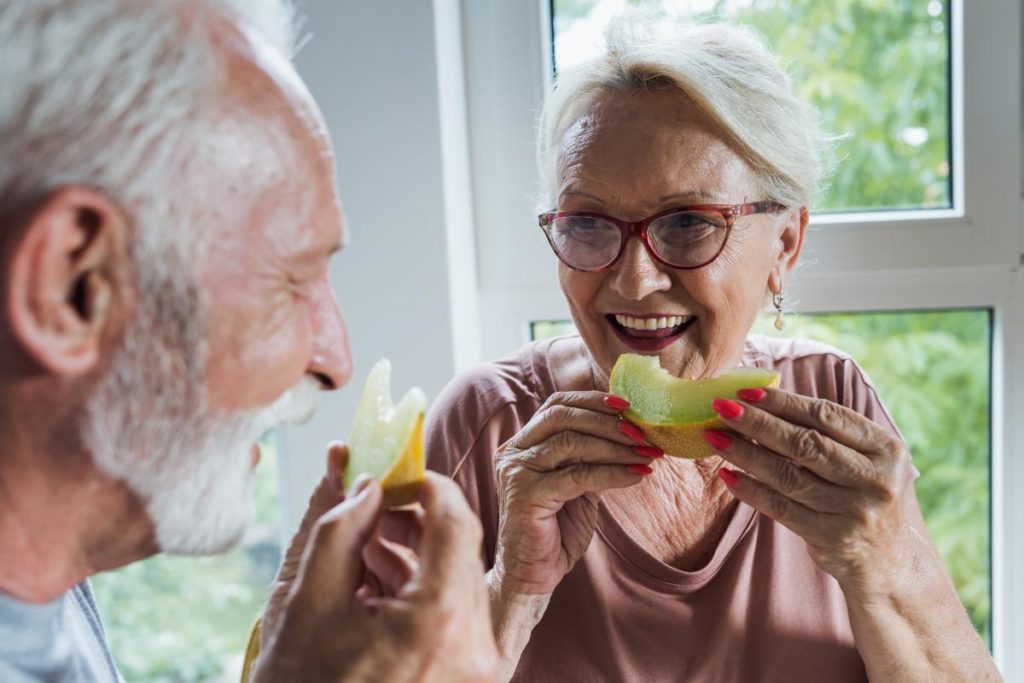 a senior couple enjoys a simple and healthy snack together