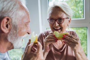 a senior couple enjoys a simple and healthy snack together