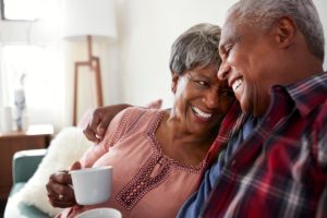 an elderly couple happily discuss their expectations of life in assisted senior living