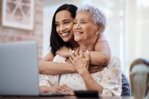 Woman hugs her grandmother while finding independent living for seniors