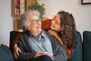 Senior being hugged by loved one in respite care