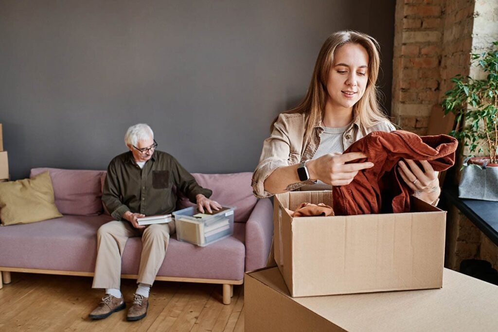 Daughter helps father move clothes into both, helping make the transition to assisted living easier for her loved one