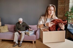 Daughter helps father move clothes into both, helping make the transition to assisted living easier for her loved one