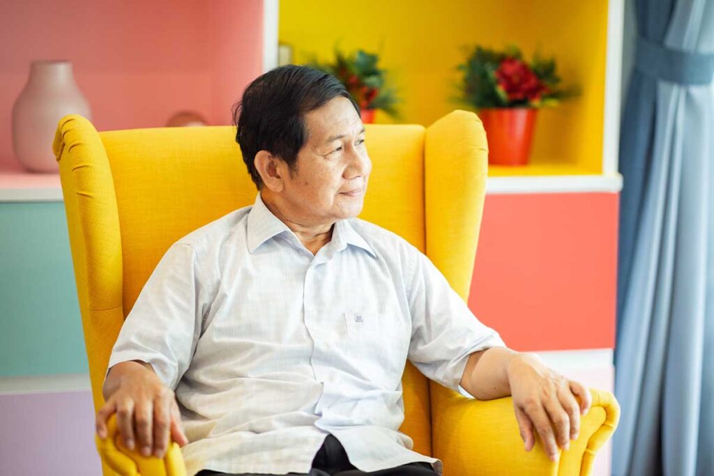 Senior sits in chair and ponders senior independent living purpose