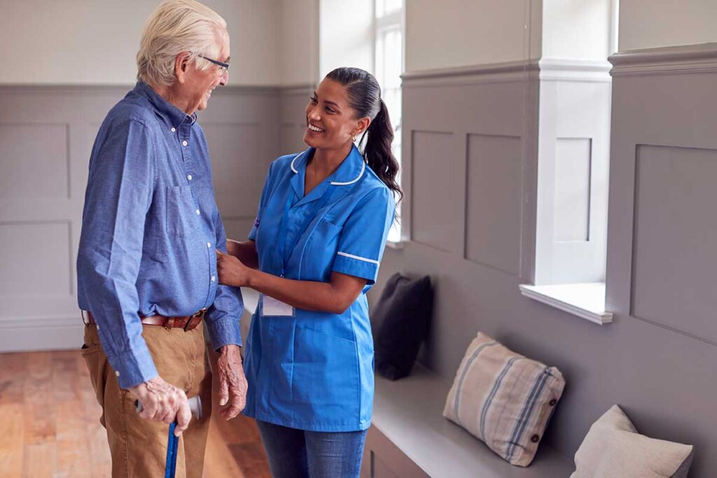 Senior smiles while talking to healthcare provider about occupational therapy benefits