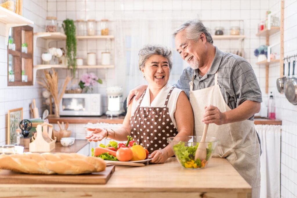 Two seniors cook after learning how to improve nutrition in the elderly