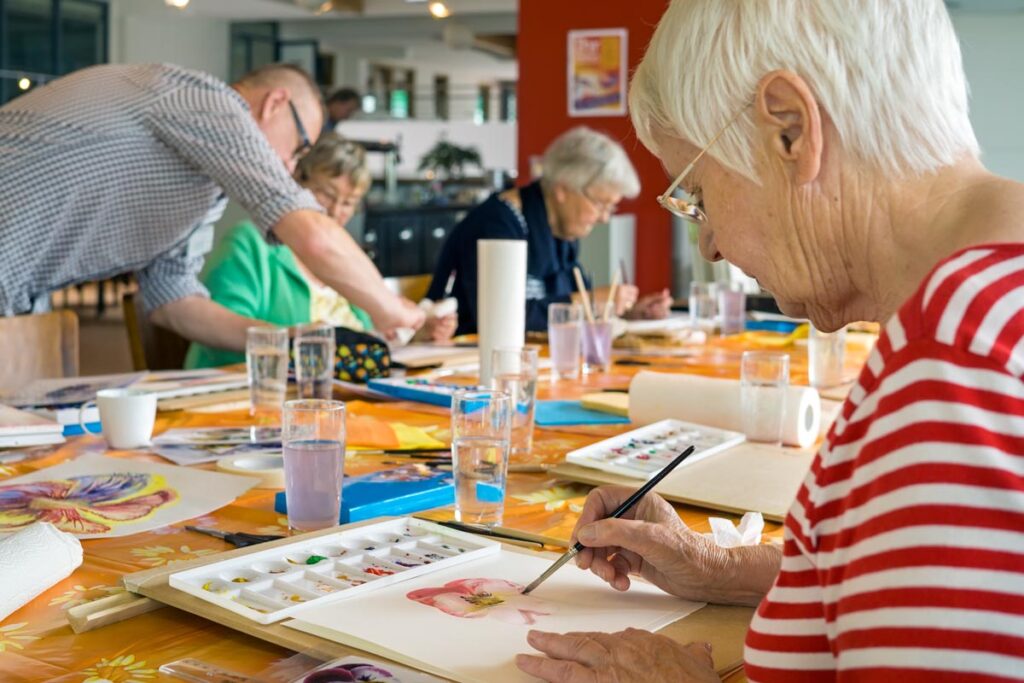 Senior paints after finding activities that are suitable for the elderly