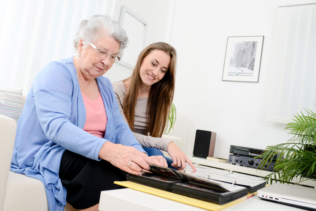 Woman helps senior grandma with task as she wonders, "how much is respite care in houston, tx?"