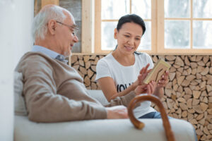 Woman talks to senior father as she wonders who respite care is for