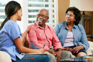 Senior smiles while talking to family and nurse about the benefits of long term skilled nursing care