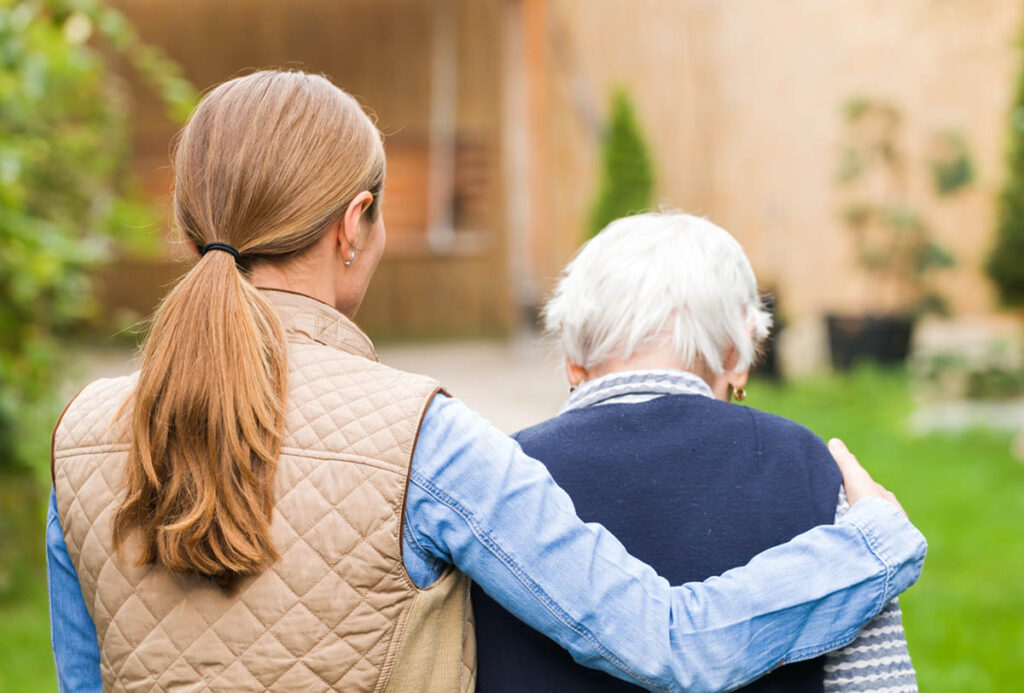 Woman wraps arm around senior as she asks, "What type of patient would you find in long term skilled nursing care?"