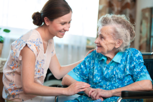 Woman touches arm of grandmother as she wonders, "how can I take a break from caring for a senior?"
