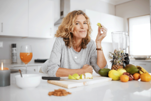 a person eats a variety of fruits and veggies to show dieting as a senior