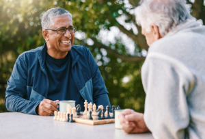 two seniors play chess after learning How To Keep Your Mind Healthy While You Age