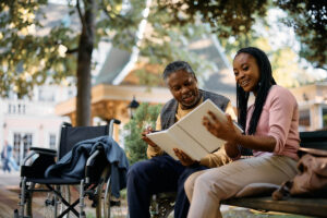 Woman shows material to senior father about supporting loved one with dementia