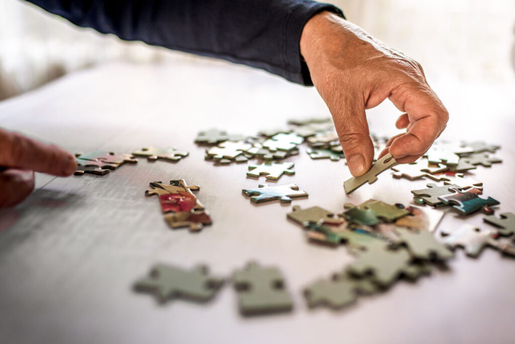 Senior puts together a puzzle during personalized memory care