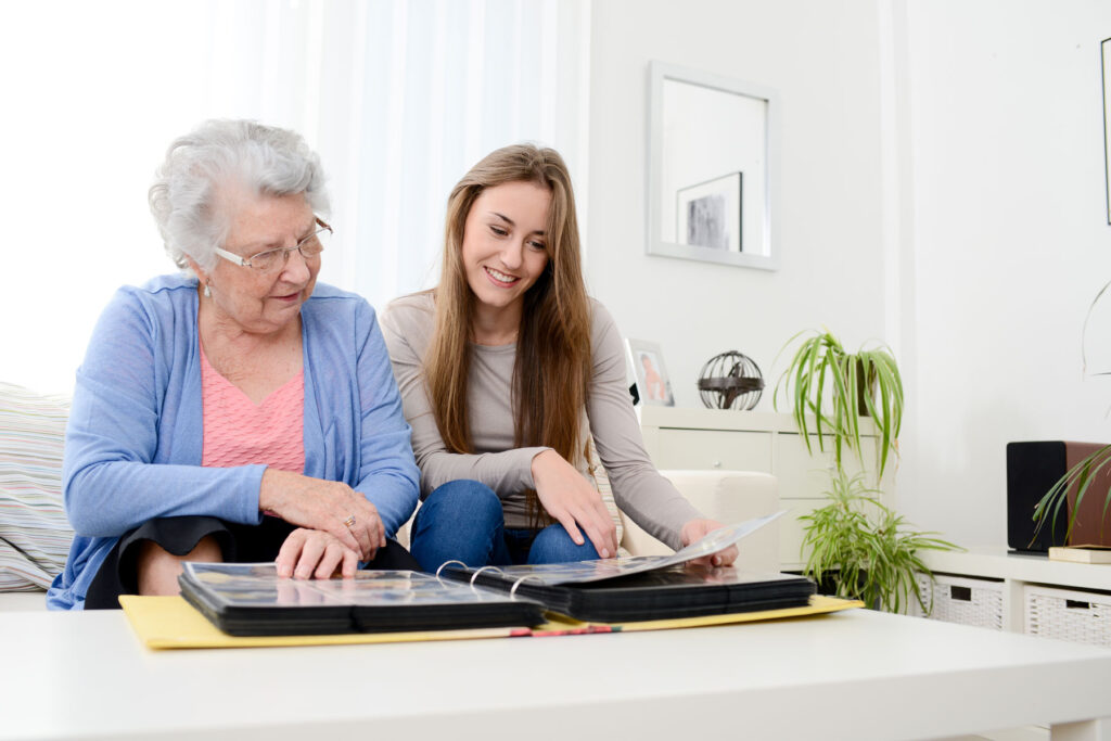 Senior woman asks woman, "what is memory care like?"
