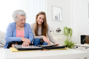 Senior woman asks woman, "what is memory care like?"