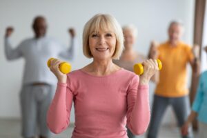 Woman lifts weights after discovering how senior living communities support health
